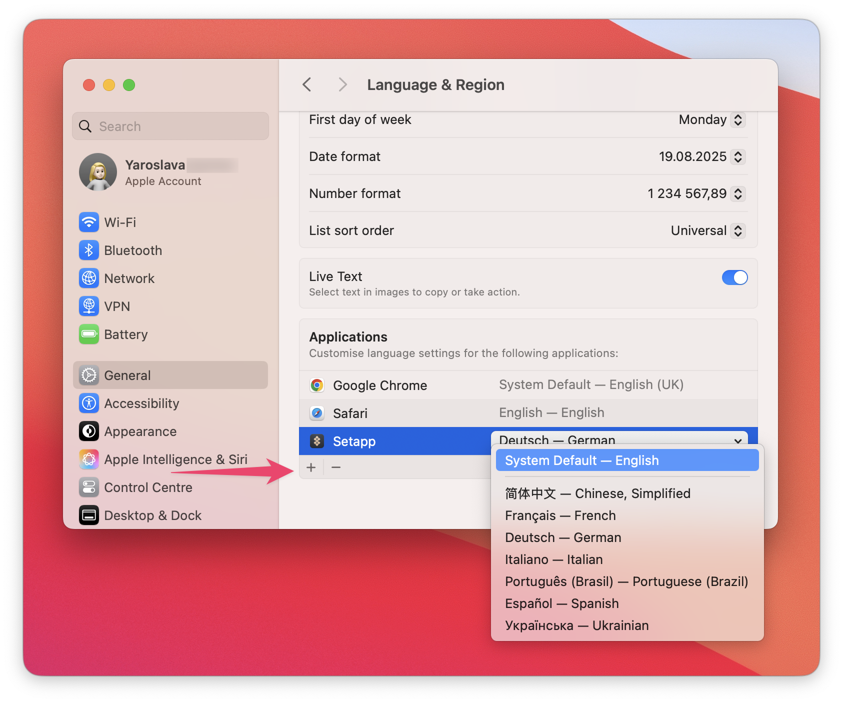 The screenshot shows the Language & Region settings on macOS with the Setapp app selected under the Applications section. A dropdown menu is open, displaying language options including English, German, French, Italian, Spanish, Ukrainian, and others. An arrow points to the plus (+) button to add a new app-specific language setting.